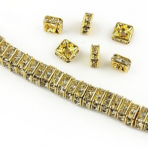 Distantiere aurii cu rhinestones albe 6mm (patrate 2,5x6mm)